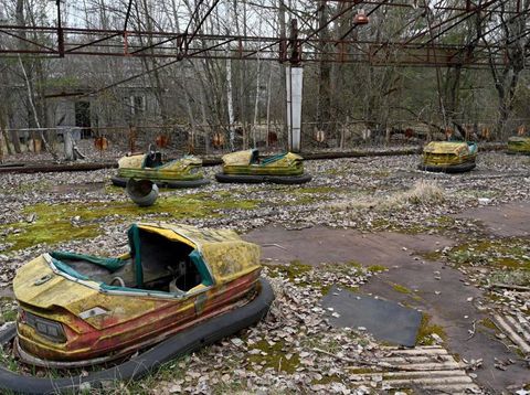 Swings and a ferris wheel remain in an abandoned amusement park of Pripyat, Ukraine. The park was scheduled to open on May 1, 1986, for the Soviet May Day celebrations. It never opened, as the Chernobyl disaster happened on April 26, 1986, a week before the opening. (Claudia Himmelreich/McClatchy DC/Tribune News Service via Getty Images)