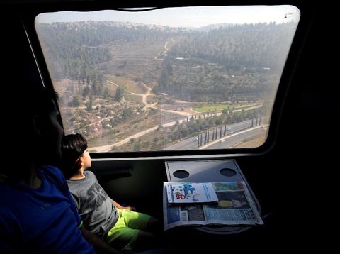 Passengers look out of a window as they travel on Israel's new high-speed rail line from Ben Gurion International Airport to Jerusalem September 25, 2018. REUTERS/Amir Cohen
